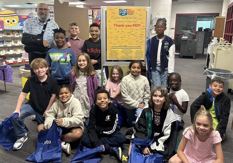 Students with books purchased with money gifted from PEP. 
