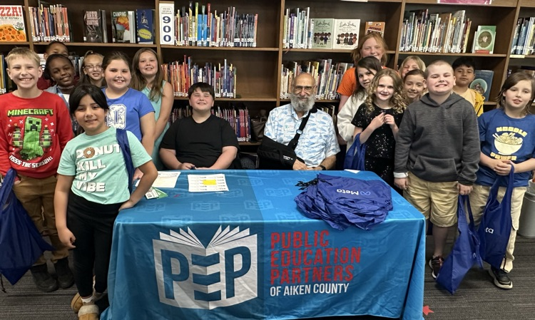 Students with books purchased with money gifted from PEP. 
