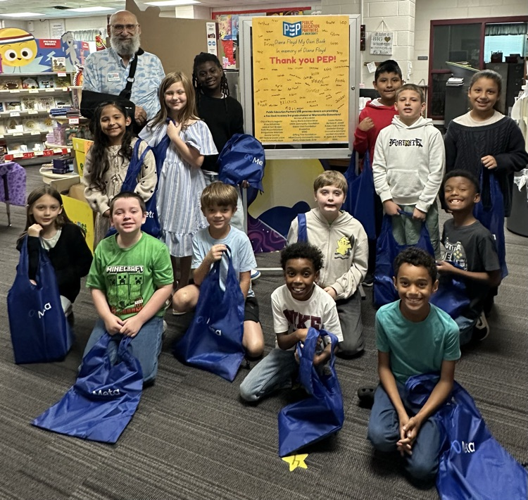 Students with books purchased with money gifted from PEP. 