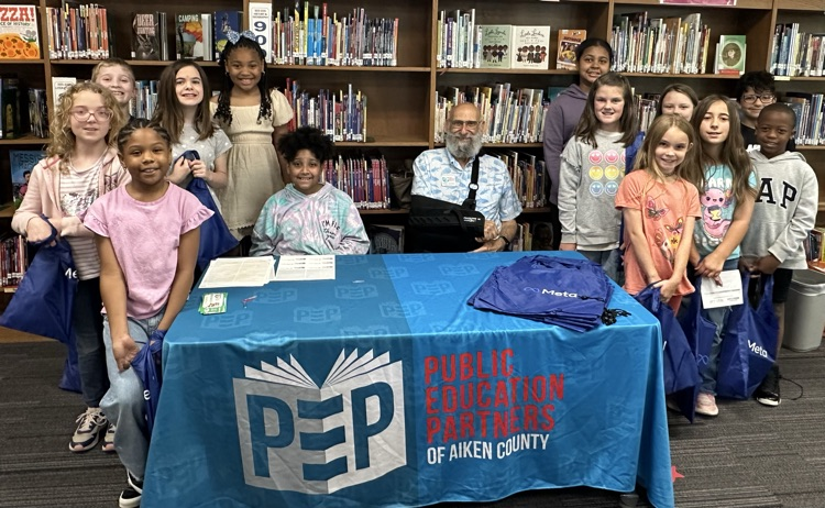 Students with books purchased with money gifted from PEP. 
