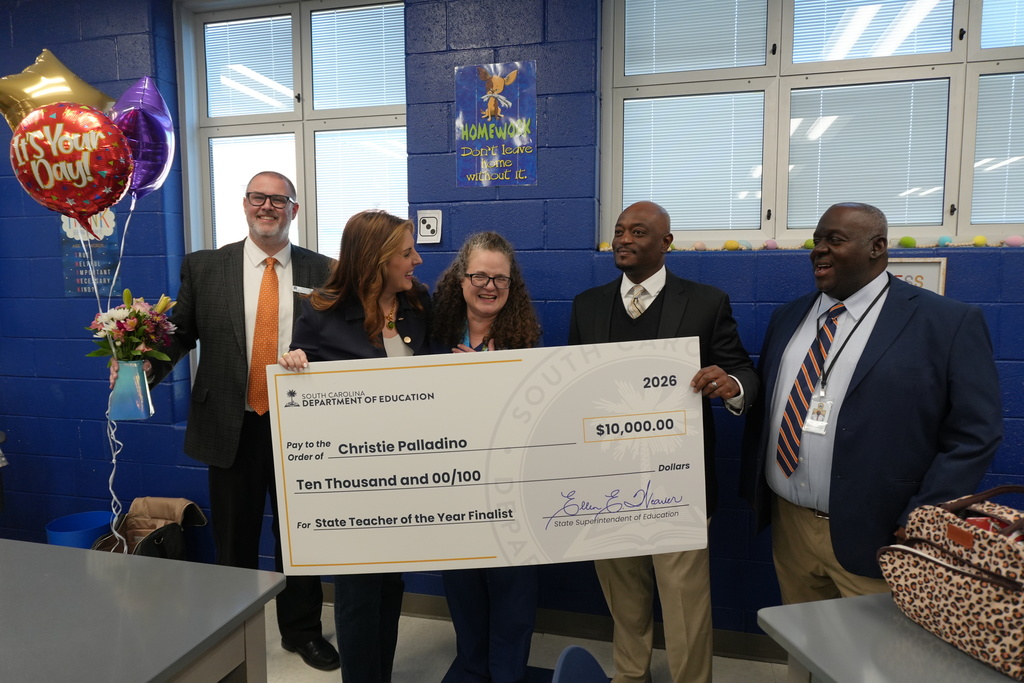 Dr. Christie Palladino being presented with $10,000 check.