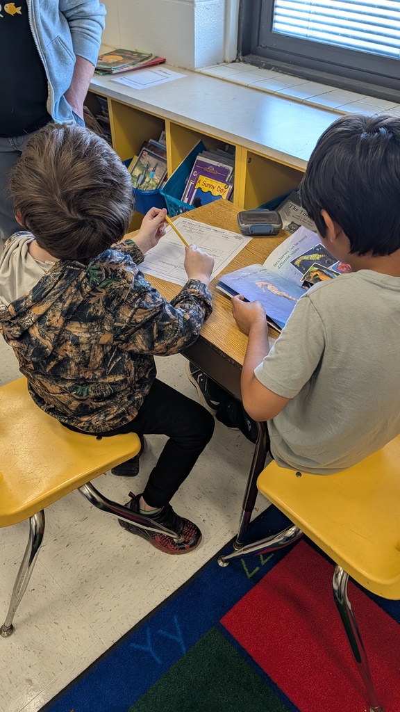 Students working together on projects at tables.