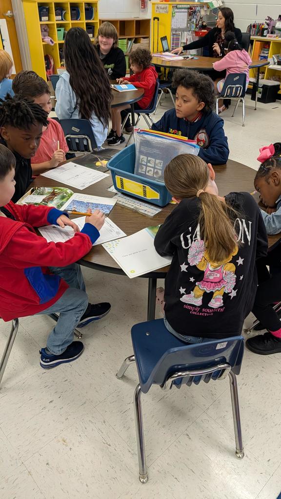 Students working together on projects at tables.