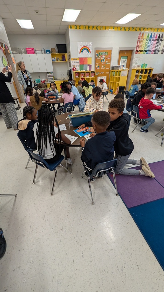 Students working together on projects at tables.
