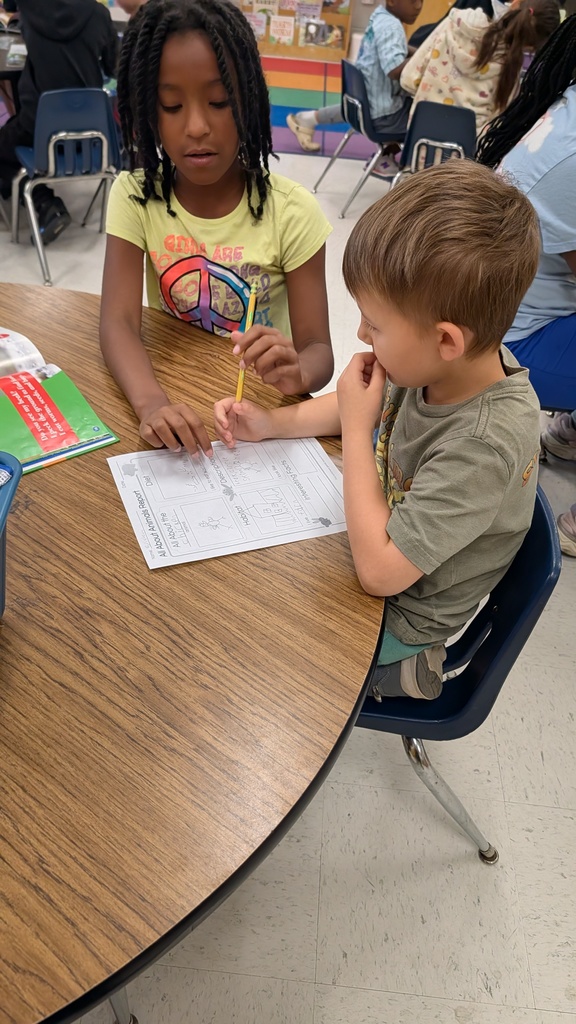 Students working together on projects at tables.