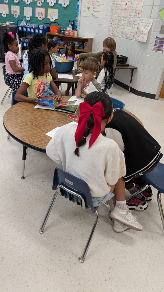 Students working together on projects at tables.