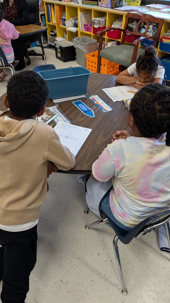 Students working together on projects at tables.