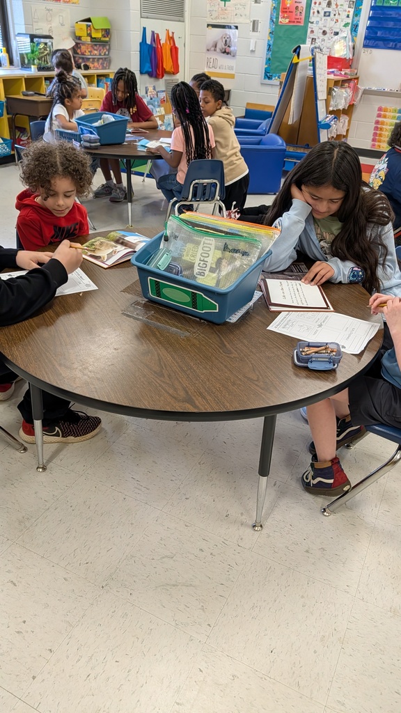 Students working together on projects at tables.