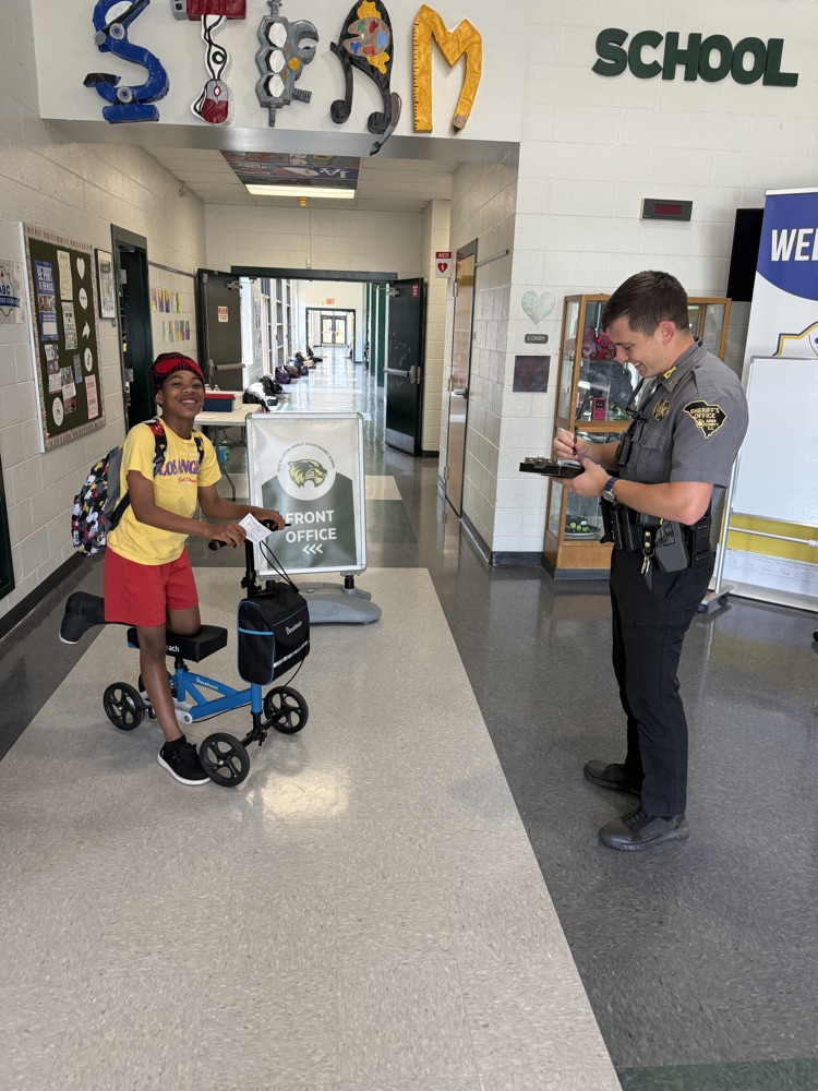 student on a knee scooter and an SRO pretending to write him a ticket 