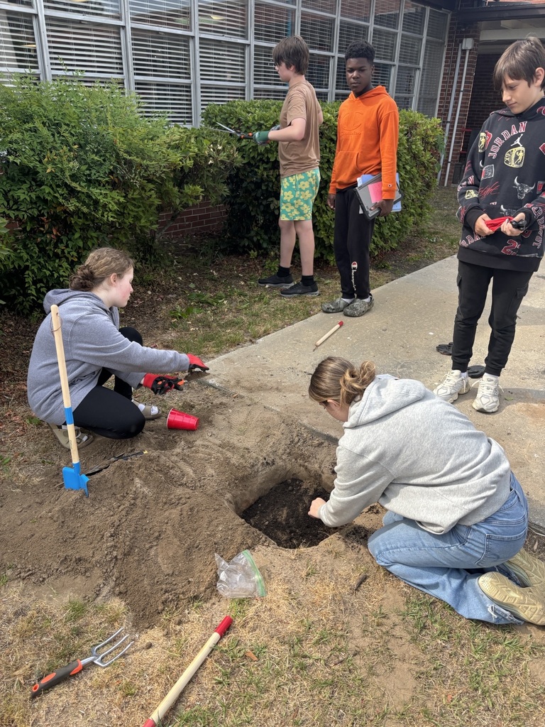 Students planting seeds.