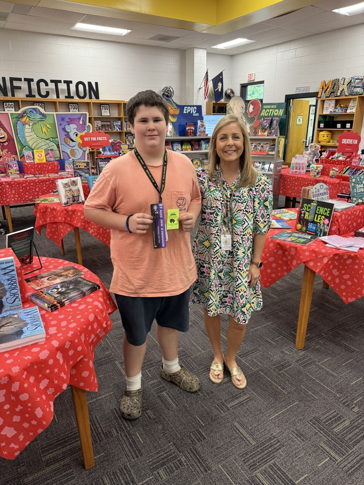 student and teacher posing at the book fair 