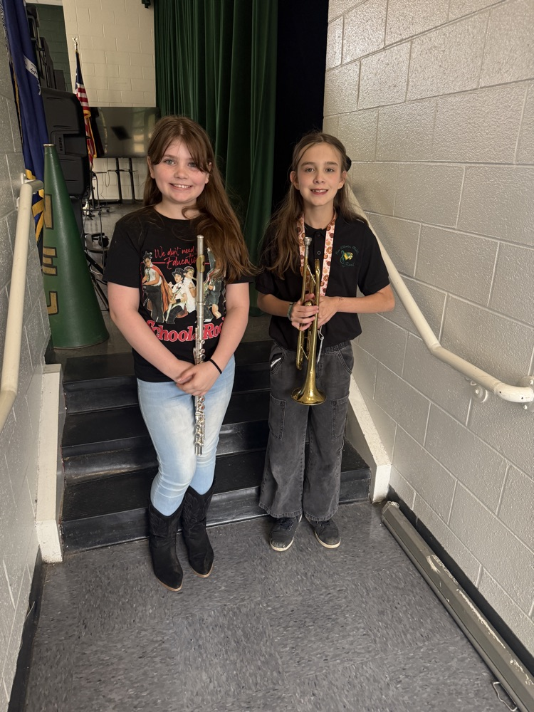 students posing with band instruments