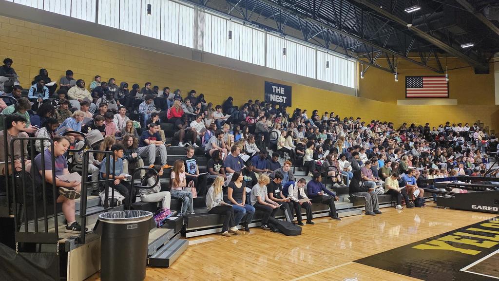 Students sitting in bleachers for assembly.