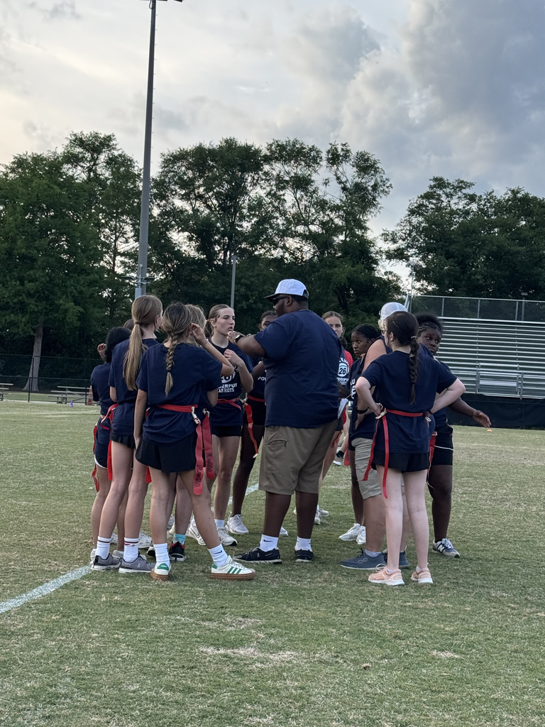 students in a team huddle
