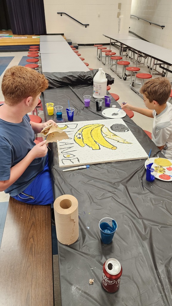 Students painting tile