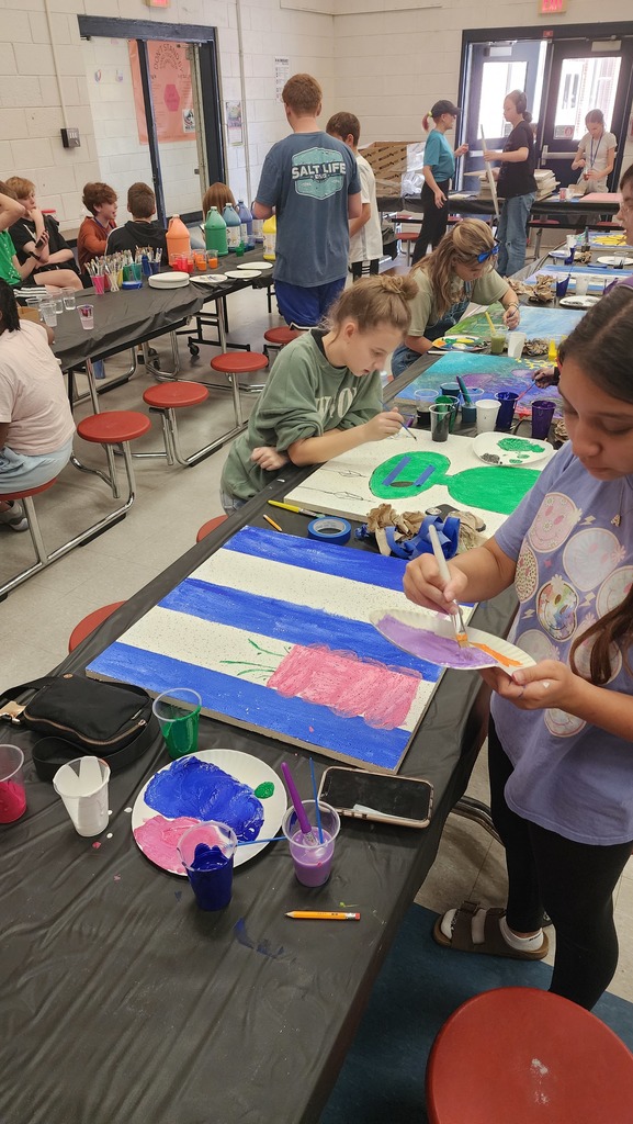 people painting ceiling tiles