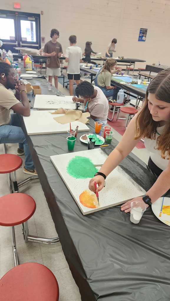 people painting ceiling tiles