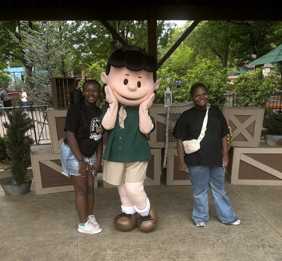 two students posing with Lucy