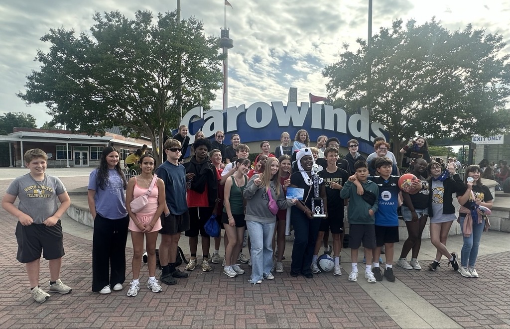 group of students around Carowinds sign