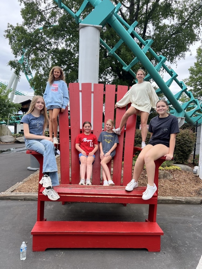 group of students on a big red chair