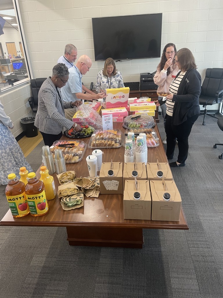 Sweet treats on table with juices and fruit with teachers. 
