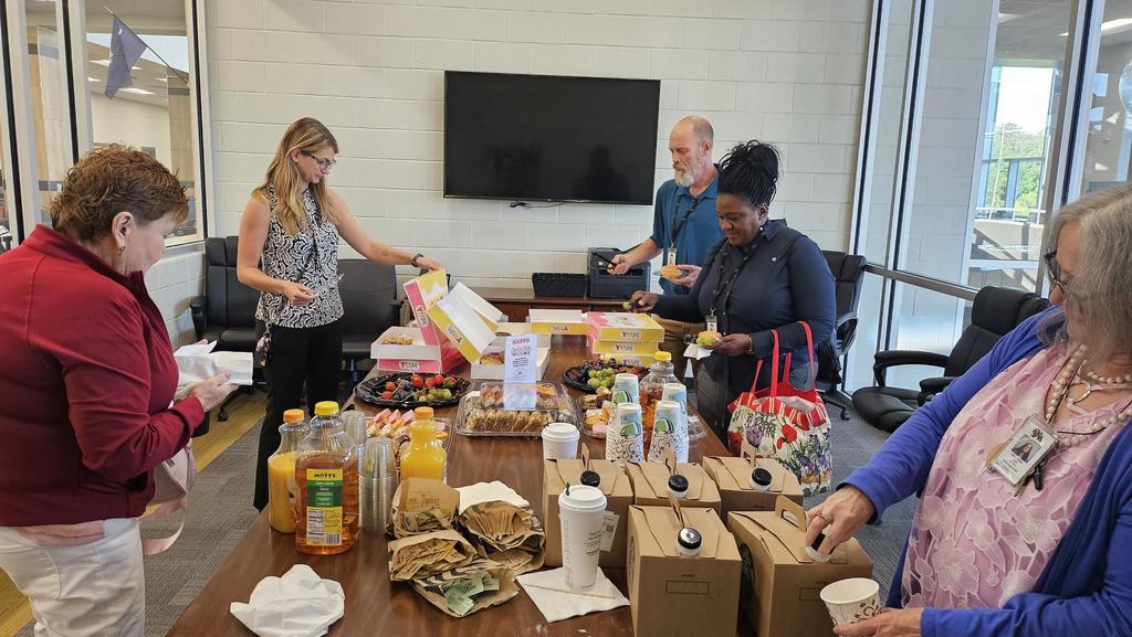 Sweet treats on table with juices and fruit with teachers. 