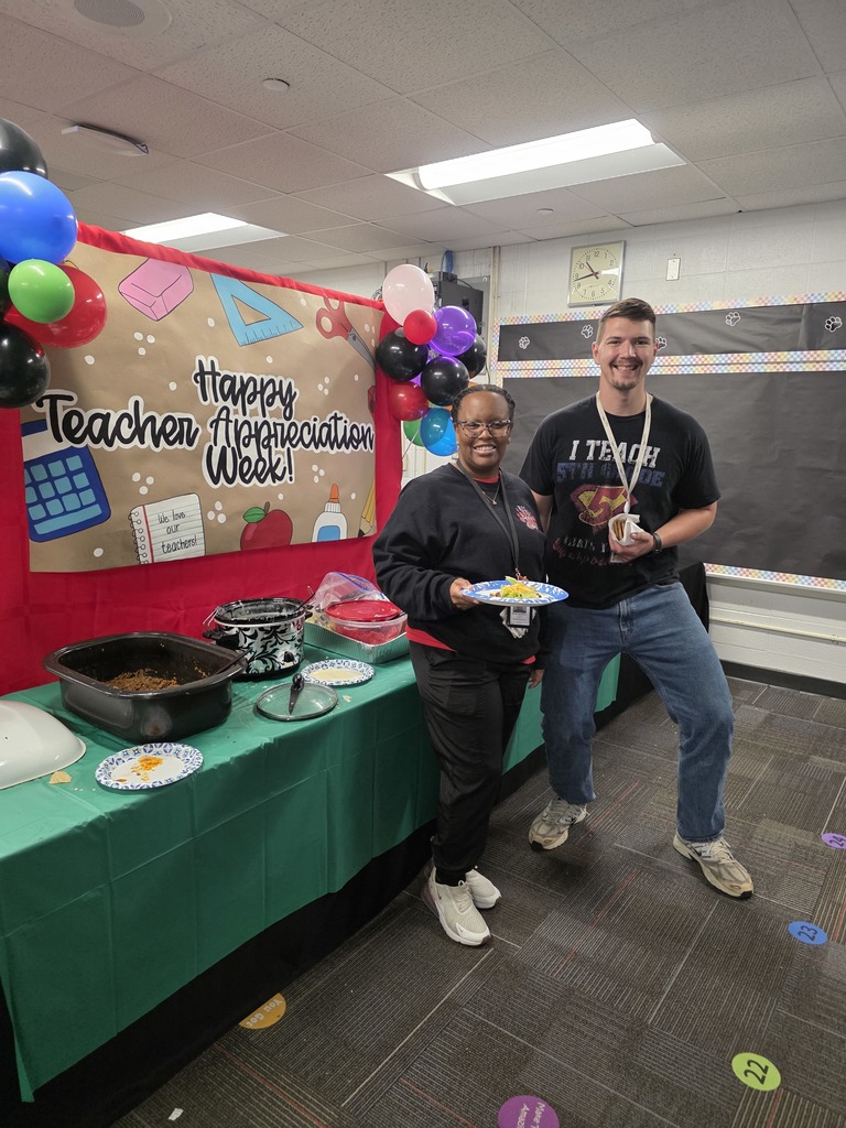 Two teachers with taco plates.