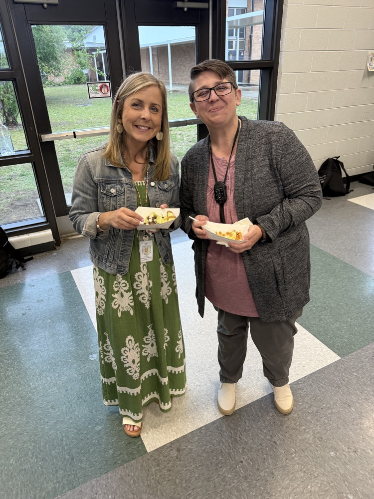 teachers holding apple treats 