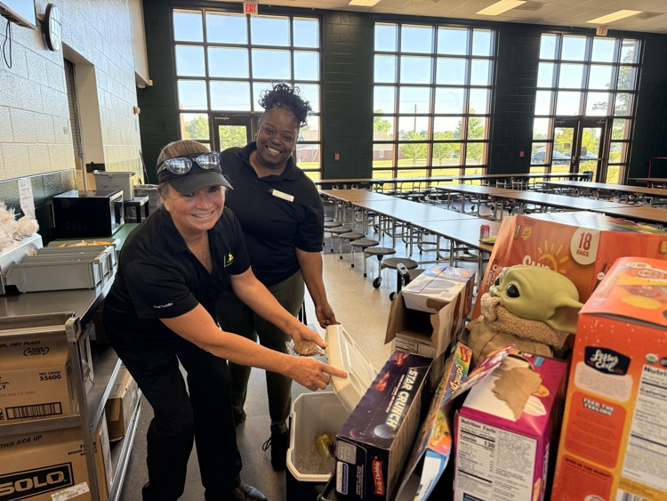 staff getting treats off a cart 