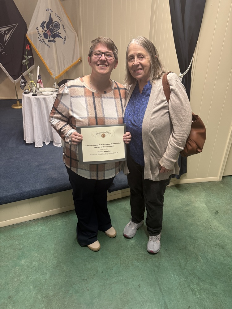 teacher standing with her mom holding certificate 