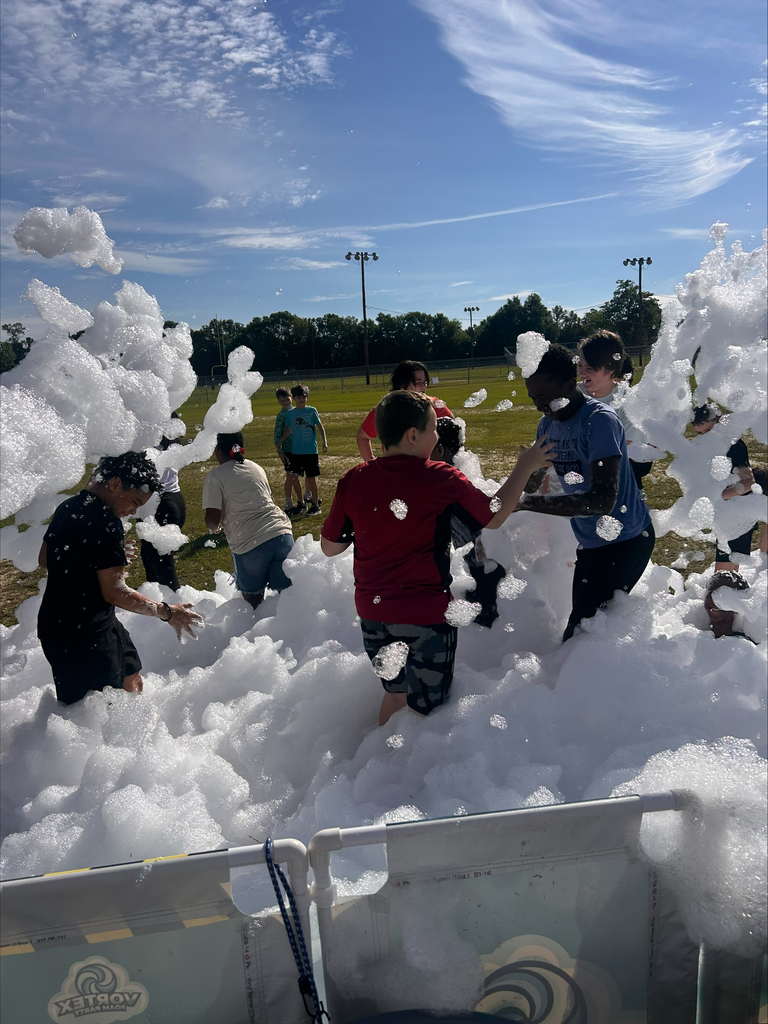 Students playing in foam during field day.