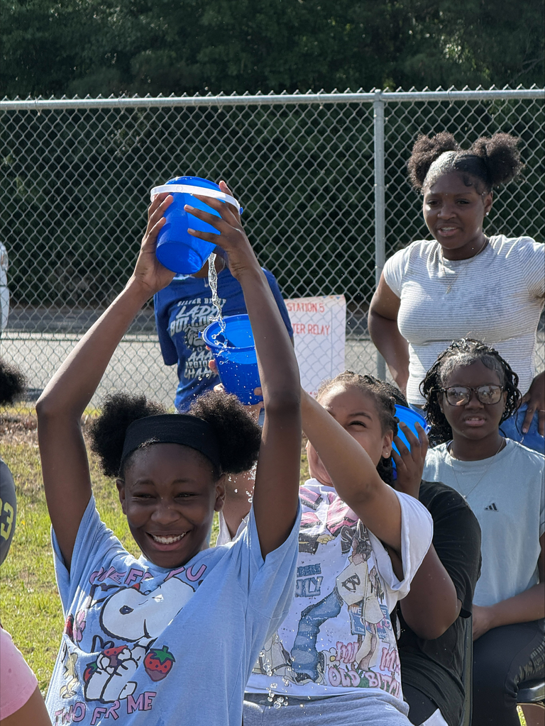 Students participating in water relay race.