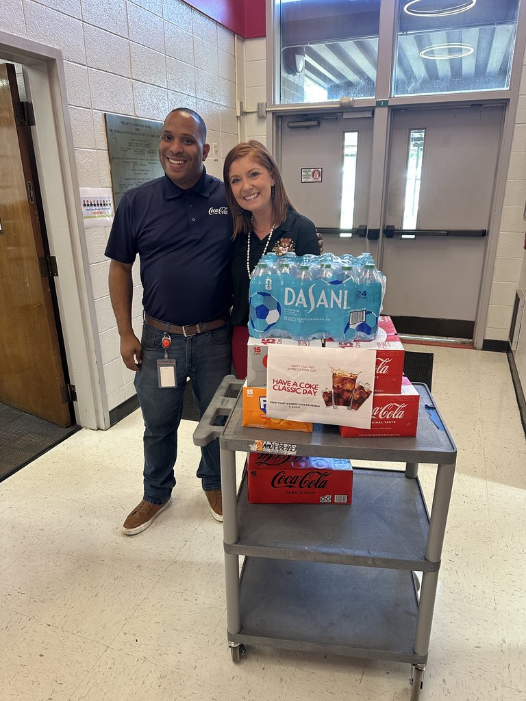 Two people with cart of drinks.