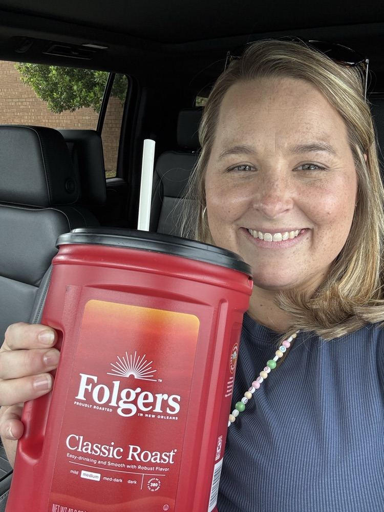 teacher holding a funny cup