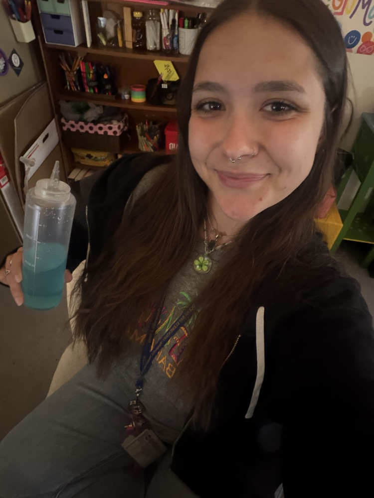 teacher holding a funny cup
