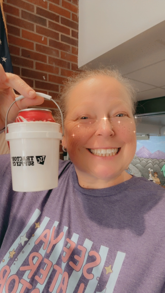 teacher holding a funny cup
