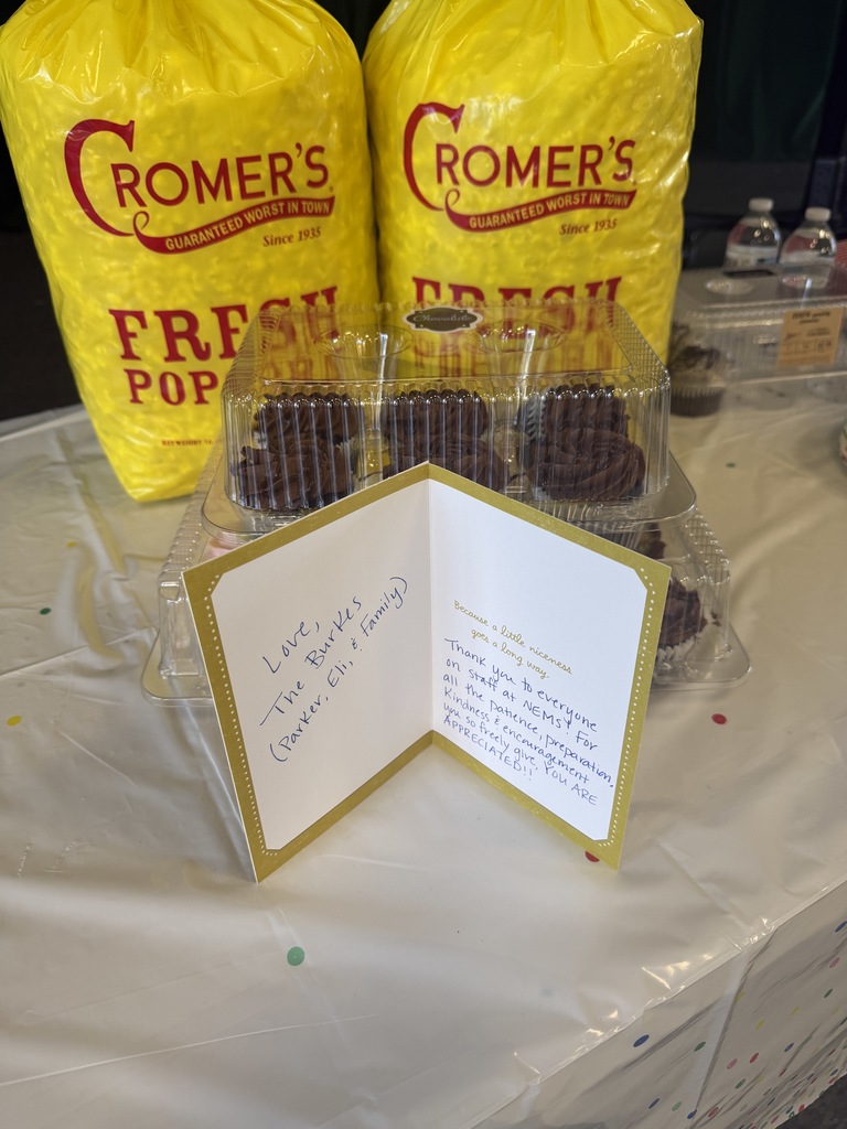 cupcakes and popcorn with a card in front 