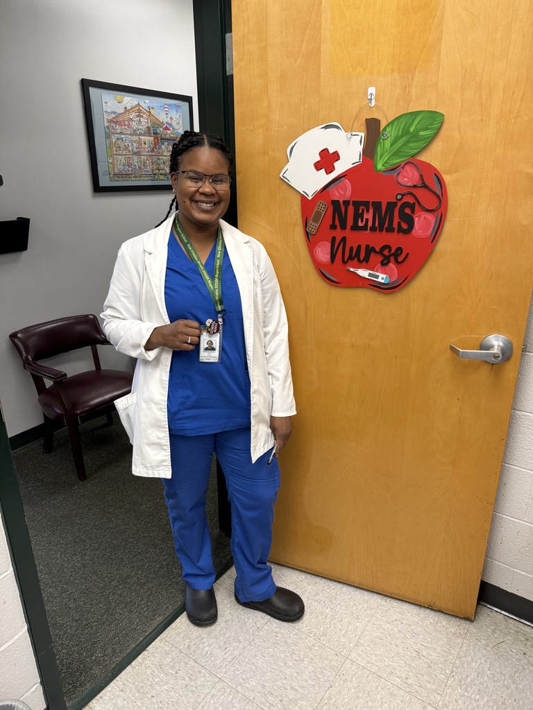 nurse standing next to a door with a sign 