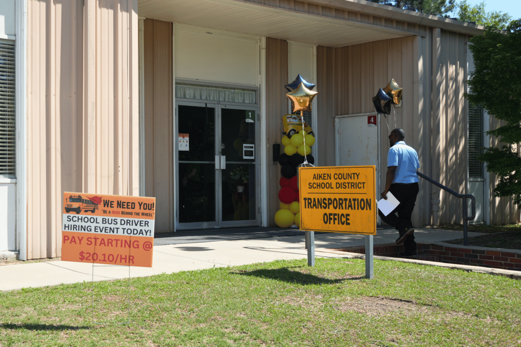 Hiring event attendee walking into transportation office.