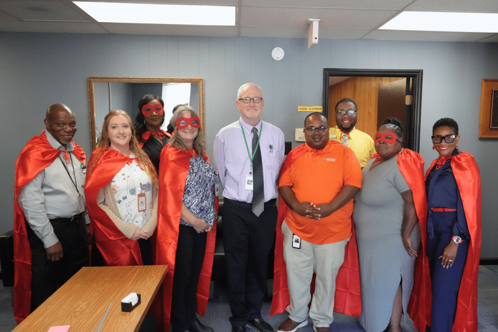 Transportation staff smiling with director of operations.
