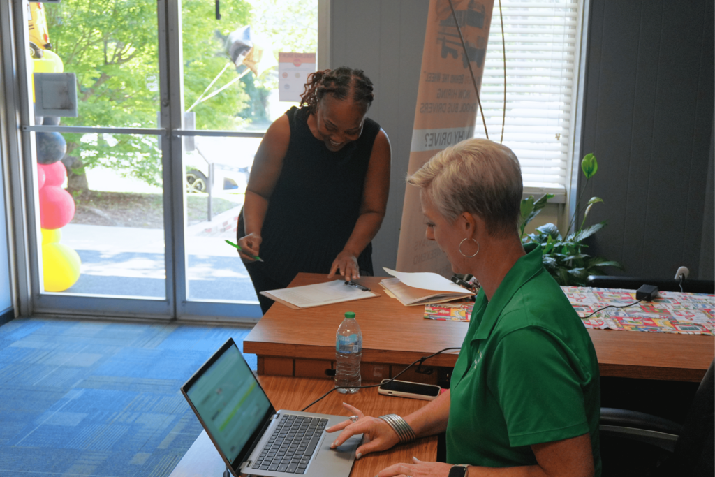 Hiring event attendee signing in at front desk.