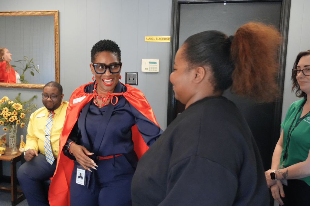 Hiring event attendee smiling with transportation director.