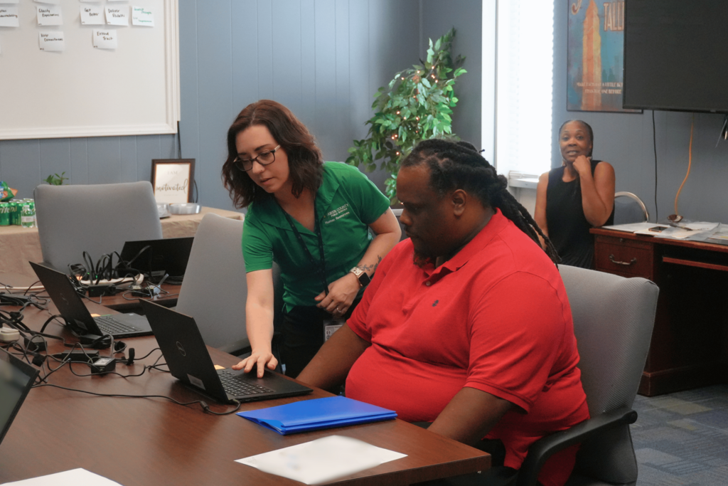 Hiring event attendee receiving help from HR recruiter.