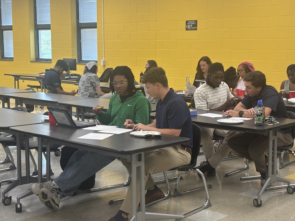 Students in classroom with tutors assisting. 