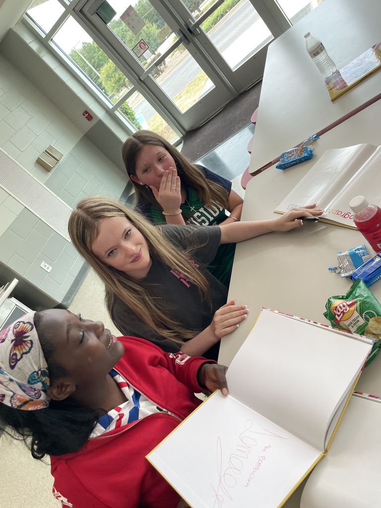 Girls talking at a table.