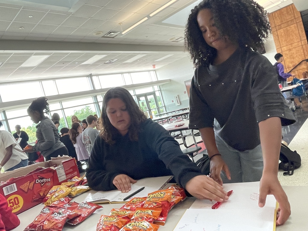 Students signing yearbooks.