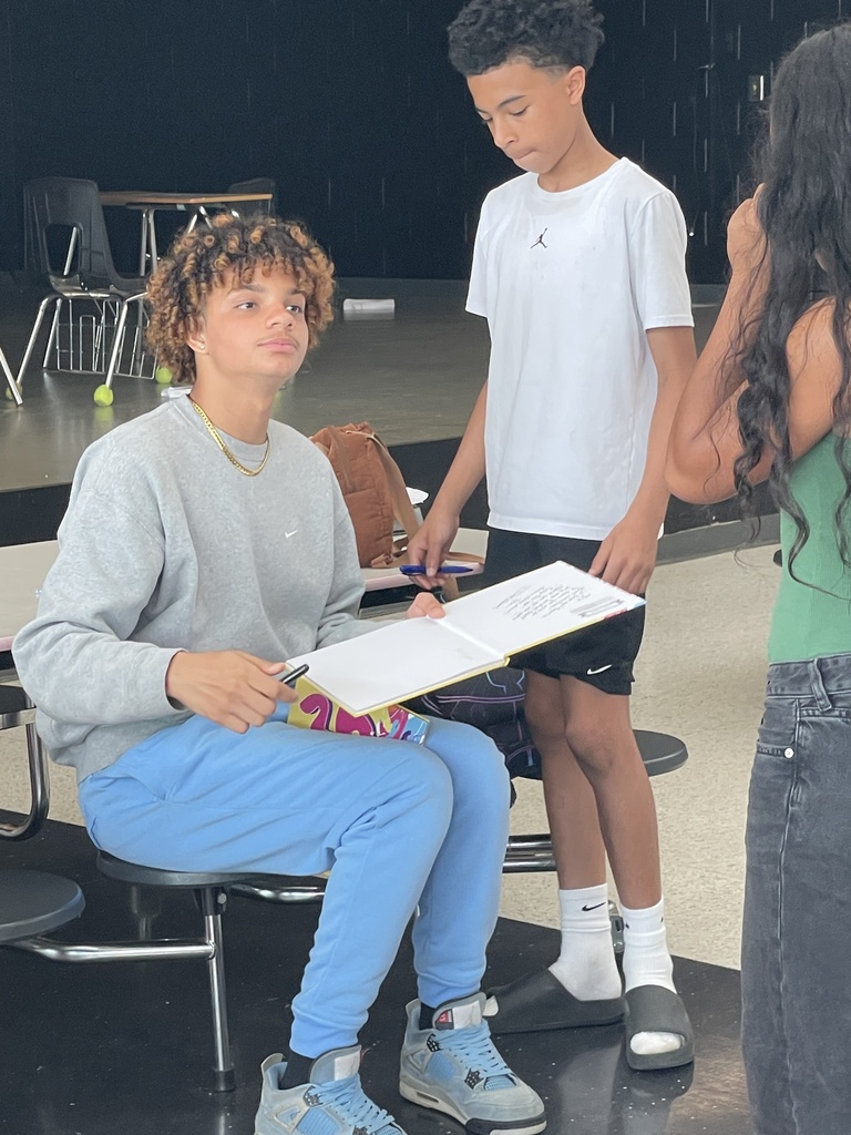 Student signing a yearbook.