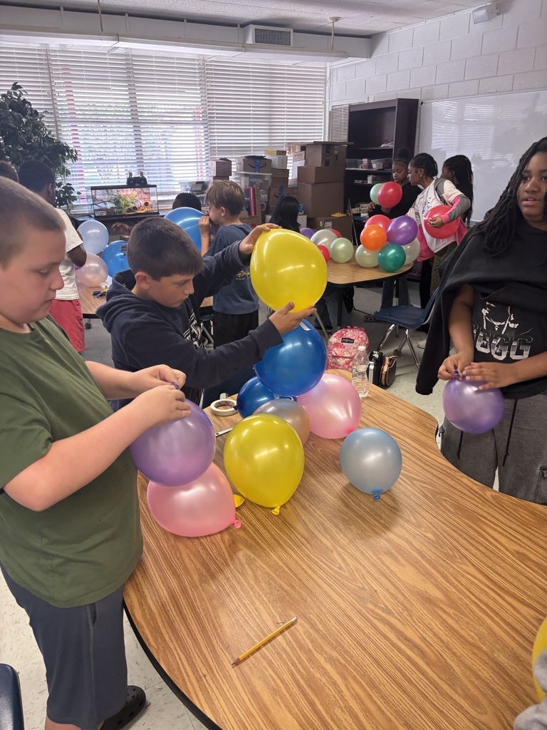 Students building largest balloon tower.
