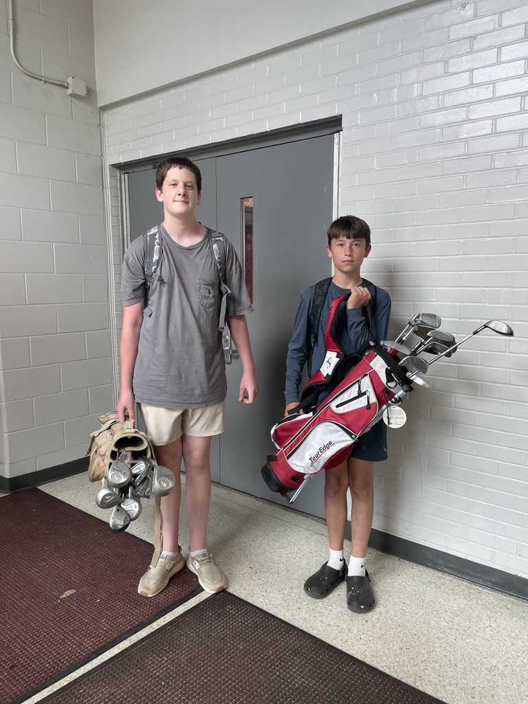 Two boys with golf clubs.