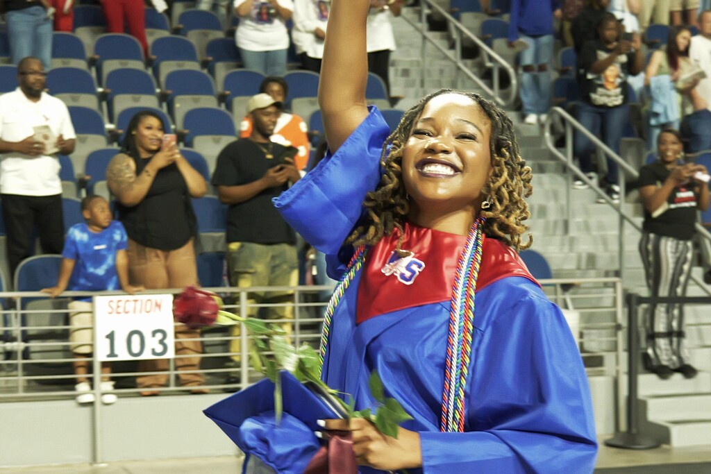 WSHS african american female graduate celebrates with her diploma. 